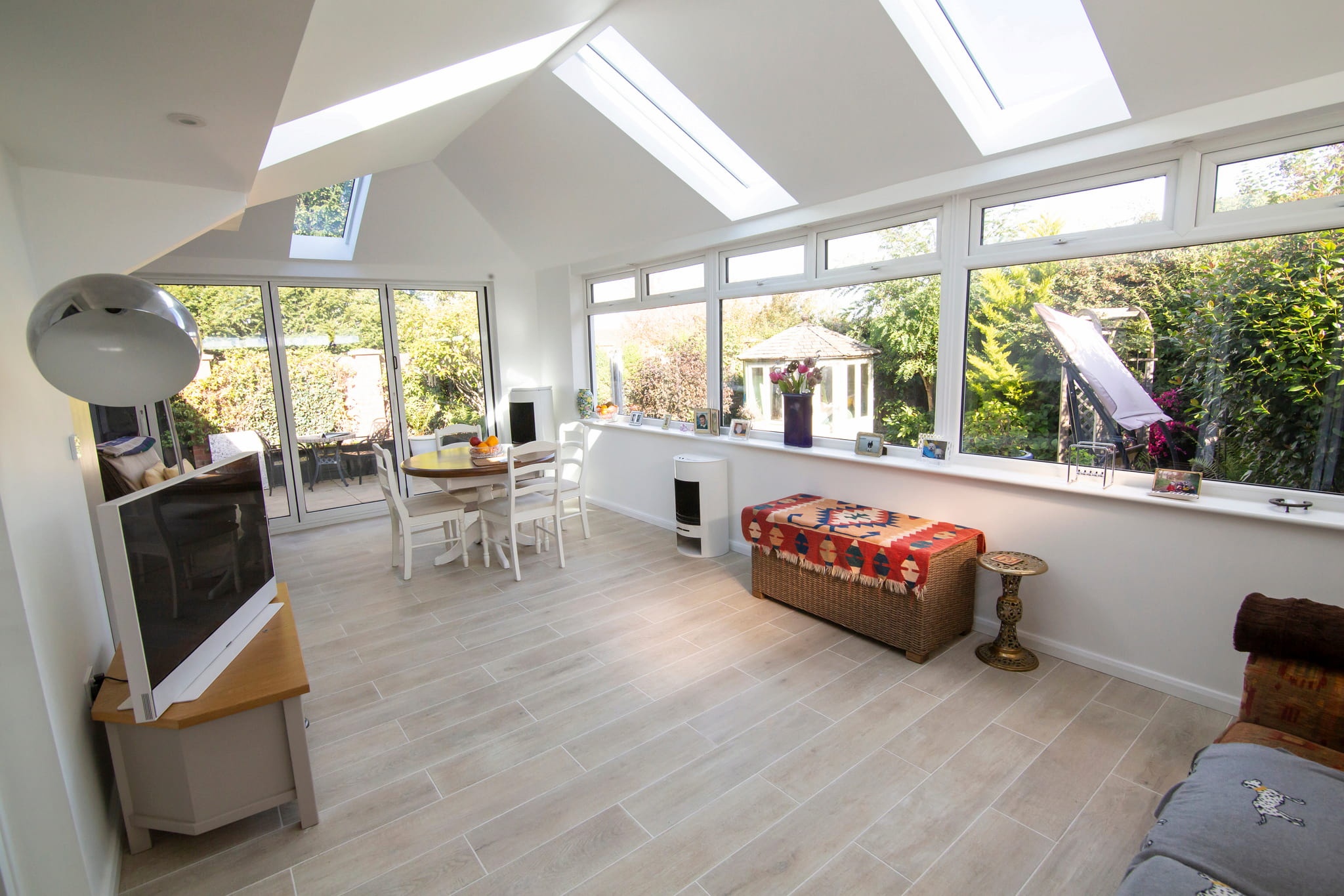 What is the difference between a house extension and a conservatory?
